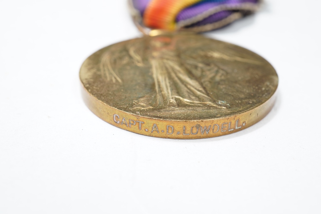 A First World War Mons Star trio awarded to Capt. A.D. Lowdell, with a clasp for 5th Aug-22nd Nov 1914, and oakleaf - mention in dispatches, together with the miniature set, plus a WWII Defence medal in its original card